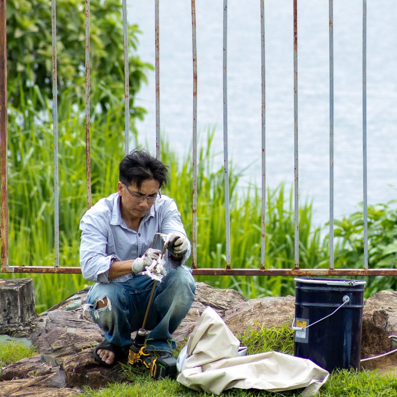 A technician performing outdoor equipment maintenance — the kind of field work that generates paperwork.